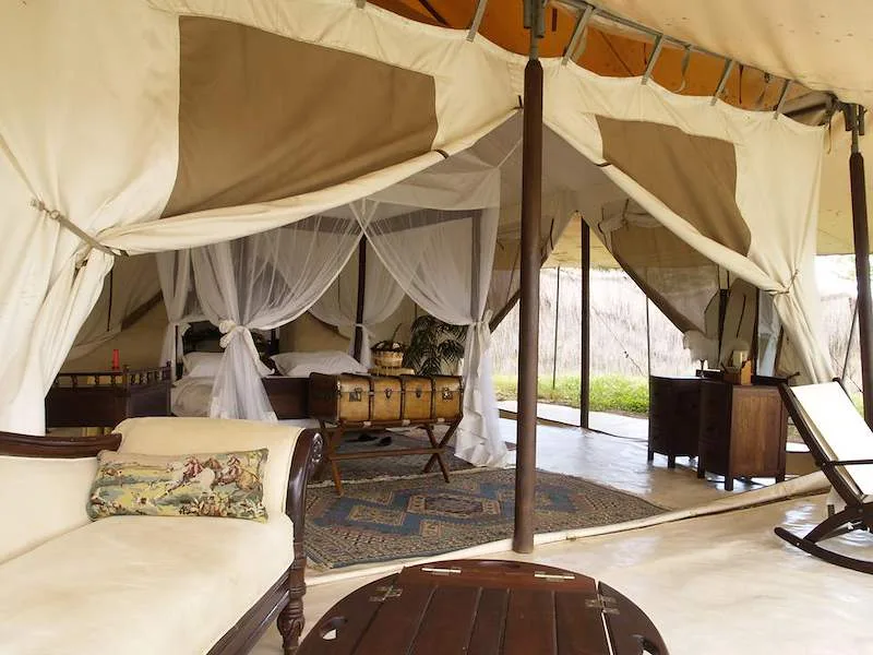 A canvas guest tent at Cottar’s 1920s Camp opens onto a shaded veranda.