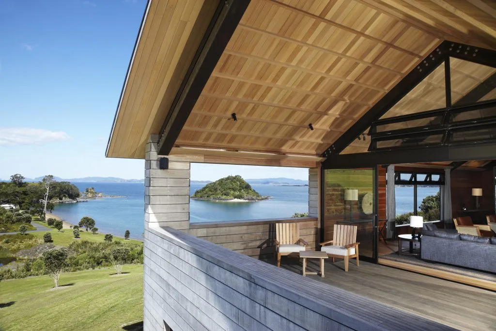 A covered balcony at The Landing looks toward green hills in the Bay of Islands.