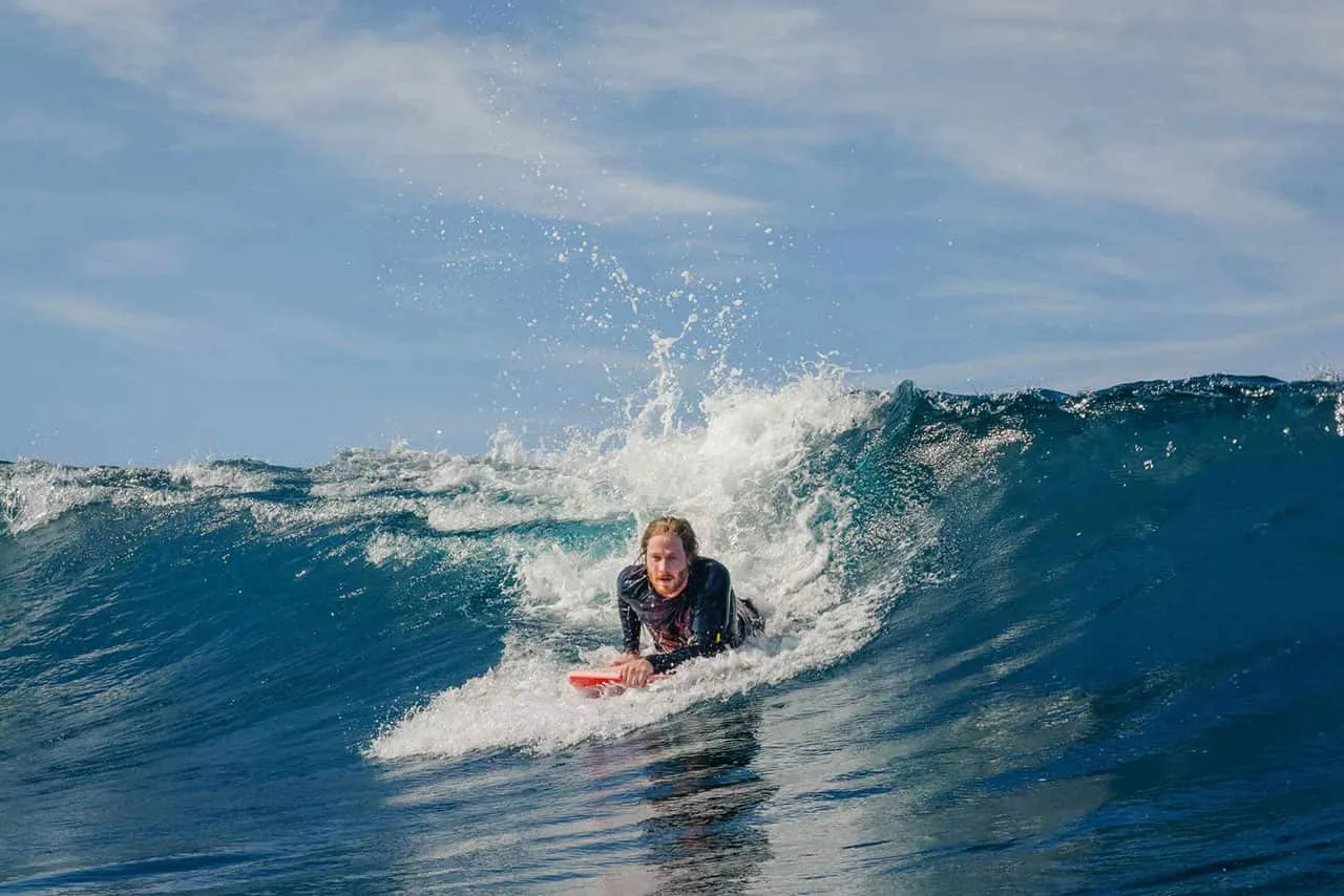 A surfer riding a breaking ocean wave.
