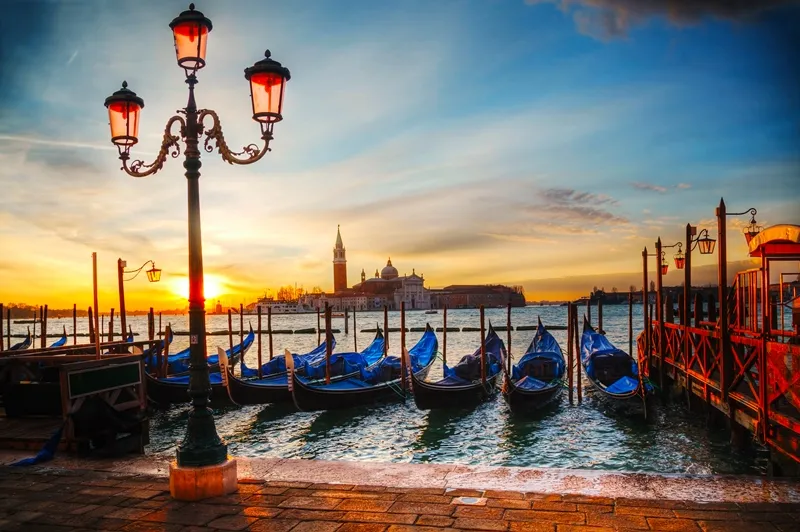 A gondola gliding past Venetian palazzi along a canal.