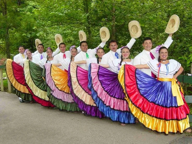 Dancers in colourful traditional costumes performing outdoors.