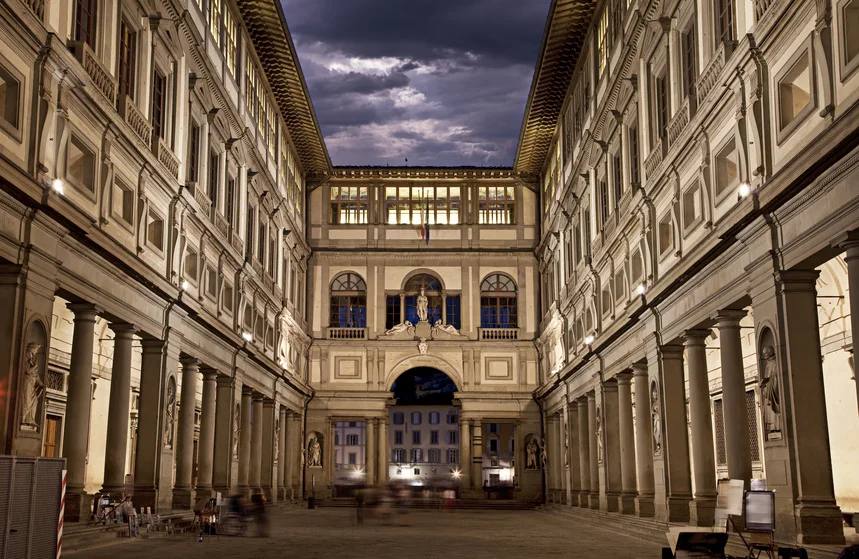 The Uffizi courtyard framed by tall buildings and columned arcades.