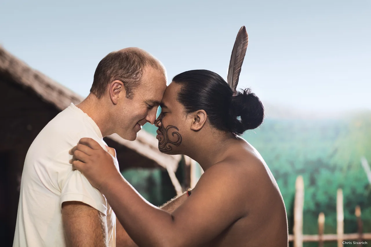 Two people greeting one another by touching noses and foreheads.