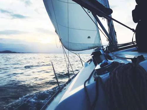 View from a sailing boat beneath its raised sail.
