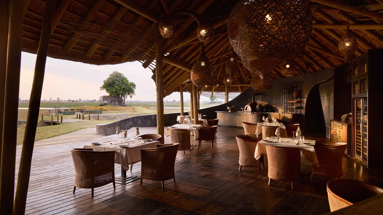 An open-air restaurant with tables overlooking the water.